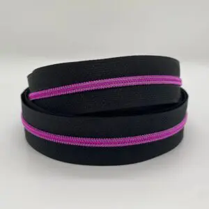 Doppelt aufgerollter Reißverschluss Intense Colors Pink Schwarz schmal mit schwarzem Band und leuchtend pinkfarbener metallisierter Spiralraupe für kreative Taschenprojekte.